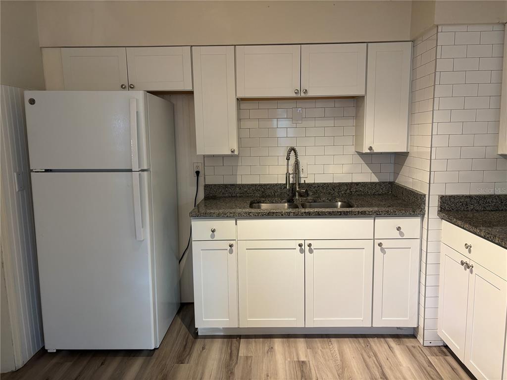 1102 Sunset Point Road, Unit 6 Clearwater, FL 33755 - Photo 10 of 31 a kitchen with a refrigerator and a stove