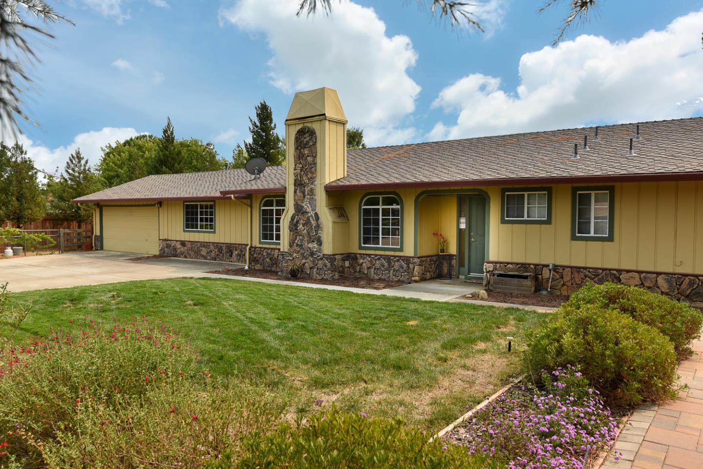 a front view of a house with garden