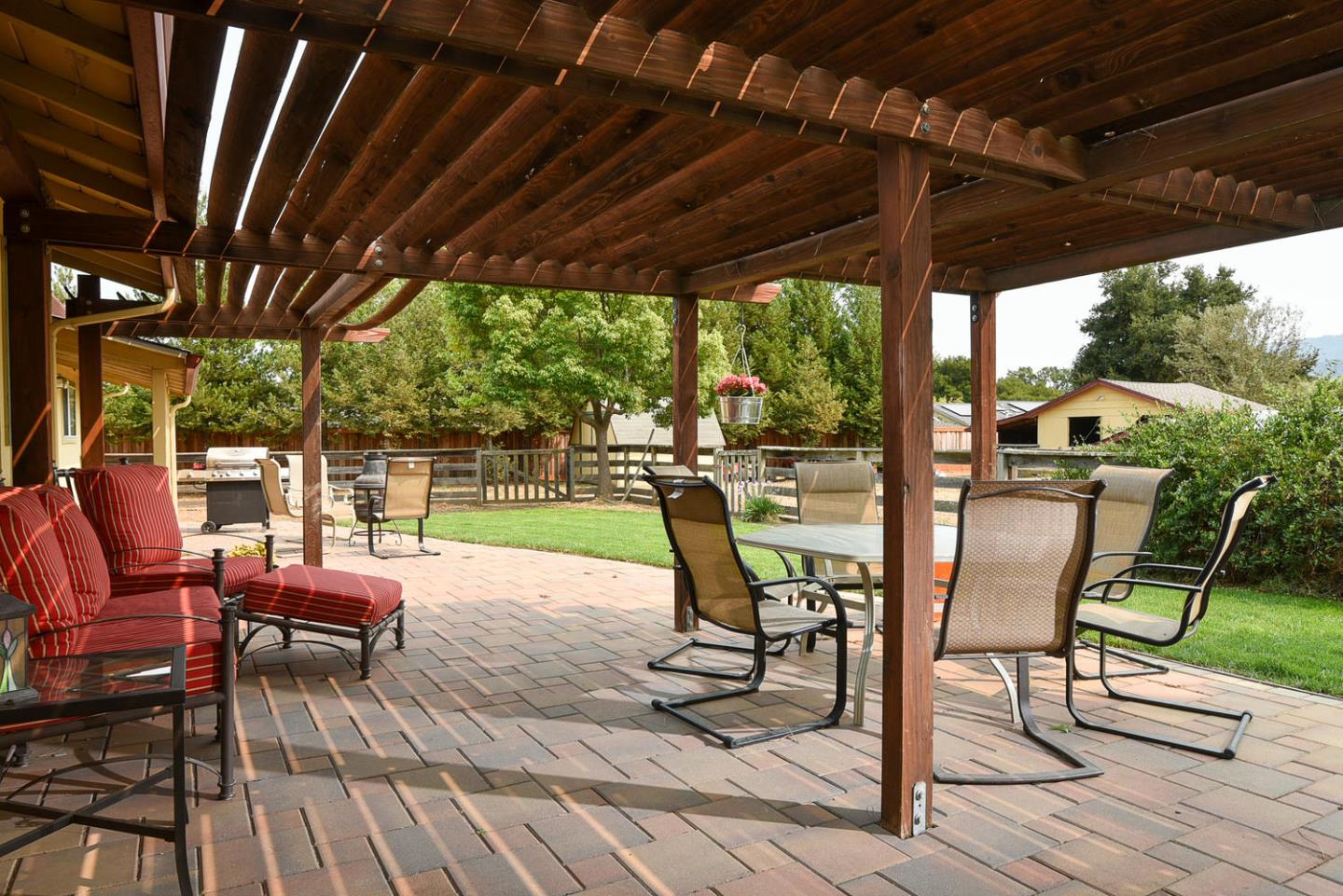 9235 Burchell Road Gilroy, CA 95020 - Photo 12 of 29 a view of a patio with table and chairs and wooden floor