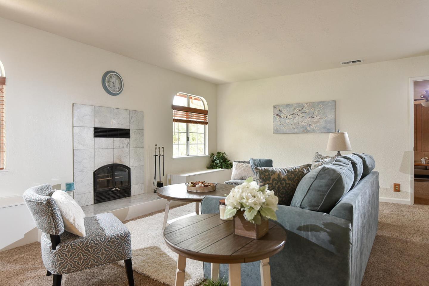9235 Burchell Road Gilroy, CA 95020 - Photo 13 of 29 a living room with furniture a fireplace and a table