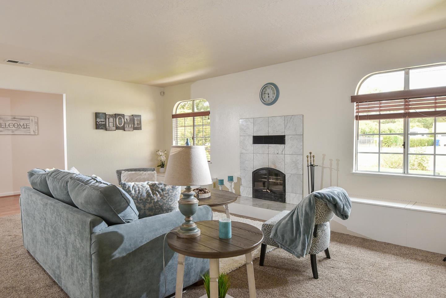 9235 Burchell Road Gilroy, CA 95020 - Photo 15 of 29 a living room with furniture a fireplace and a large window