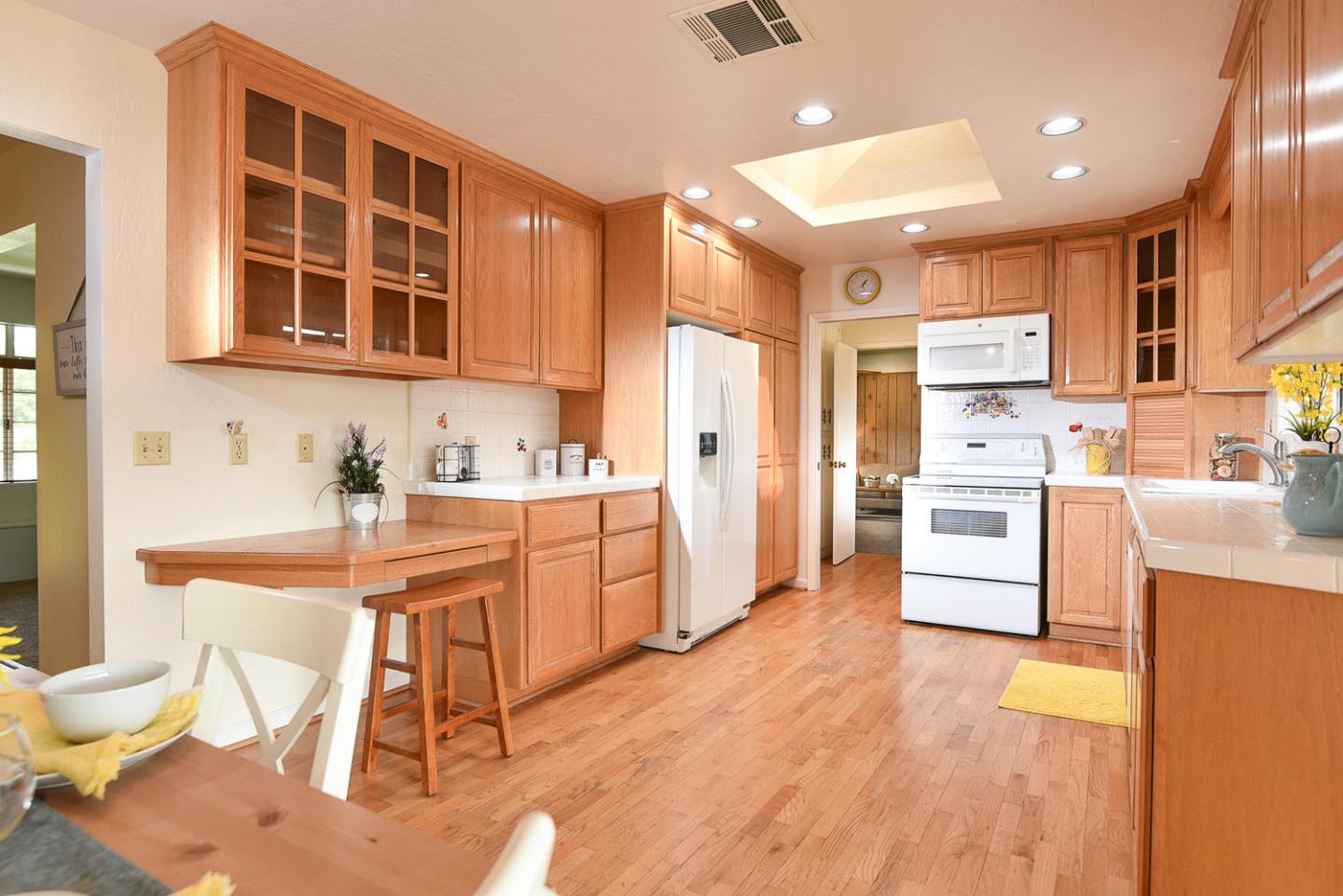 9235 Burchell Road Gilroy, CA 95020 - Photo 19 of 29 a kitchen with stainless steel appliances kitchen island granite countertop a sink and cabinets