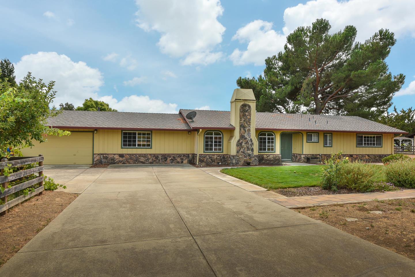 9235 Burchell Road Gilroy, CA 95020 - Photo 2 of 29 a front view of a house with a yard and a garage