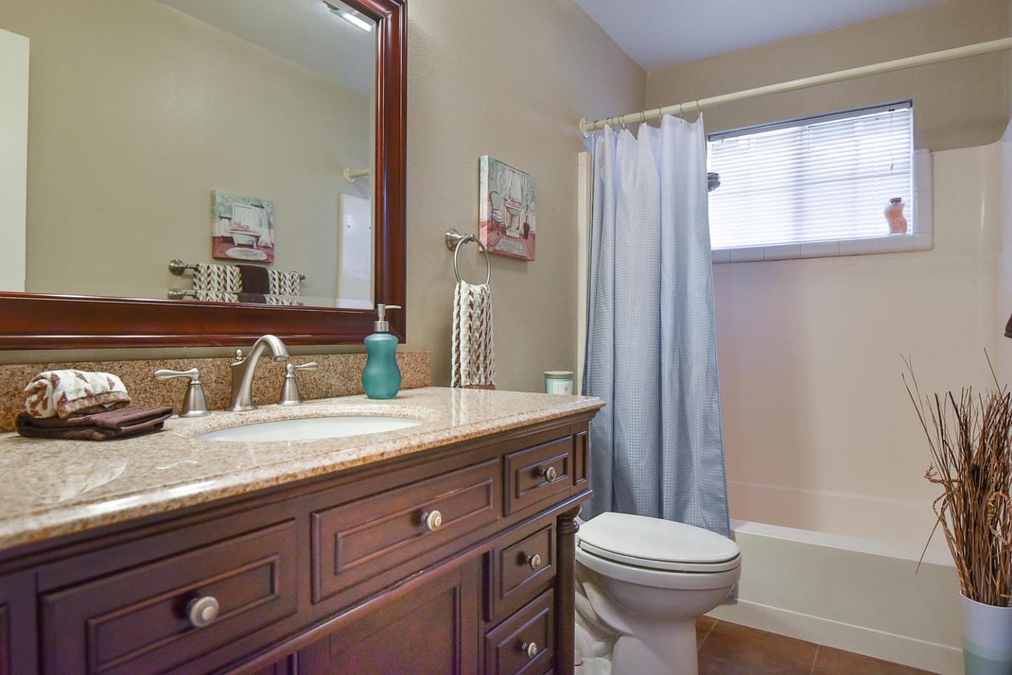 9235 Burchell Road Gilroy, CA 95020 - Photo 29 of 29 a bathroom with a granite countertop toilet sink and mirror
