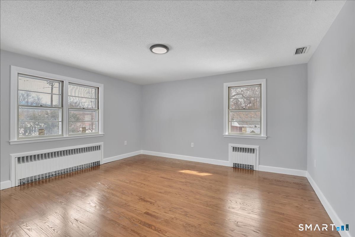 909 Randolph Road Middletown, CT 06457 - Photo 12 of 24 wooden floor in an empty room with a window