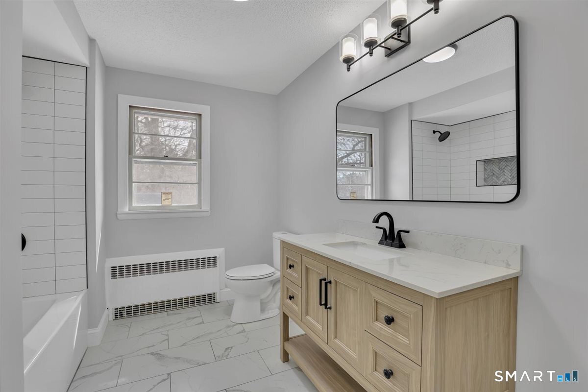 909 Randolph Road Middletown, CT 06457 - Photo 17 of 24 a bathroom with a toilet a sink and a mirror