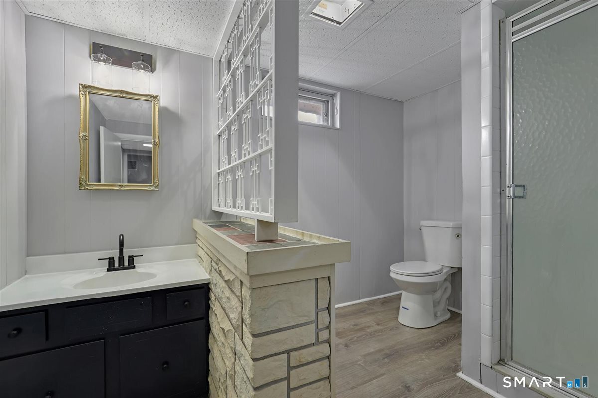 909 Randolph Road Middletown, CT 06457 - Photo 18 of 24 a bathroom with a sink toilet and vanity