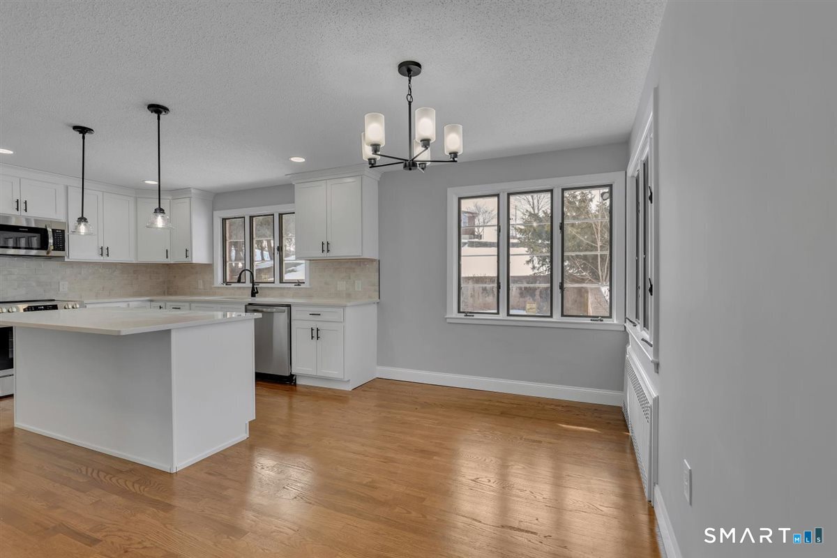 909 Randolph Road Middletown, CT 06457 - Photo 6 of 24 a kitchen with kitchen island white cabinets and window
