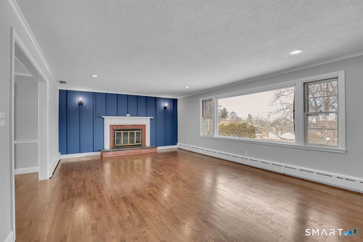 909 Randolph Road Middletown, CT 06457 - Photo 9 of 24 a view of an empty room with a window and wooden floor