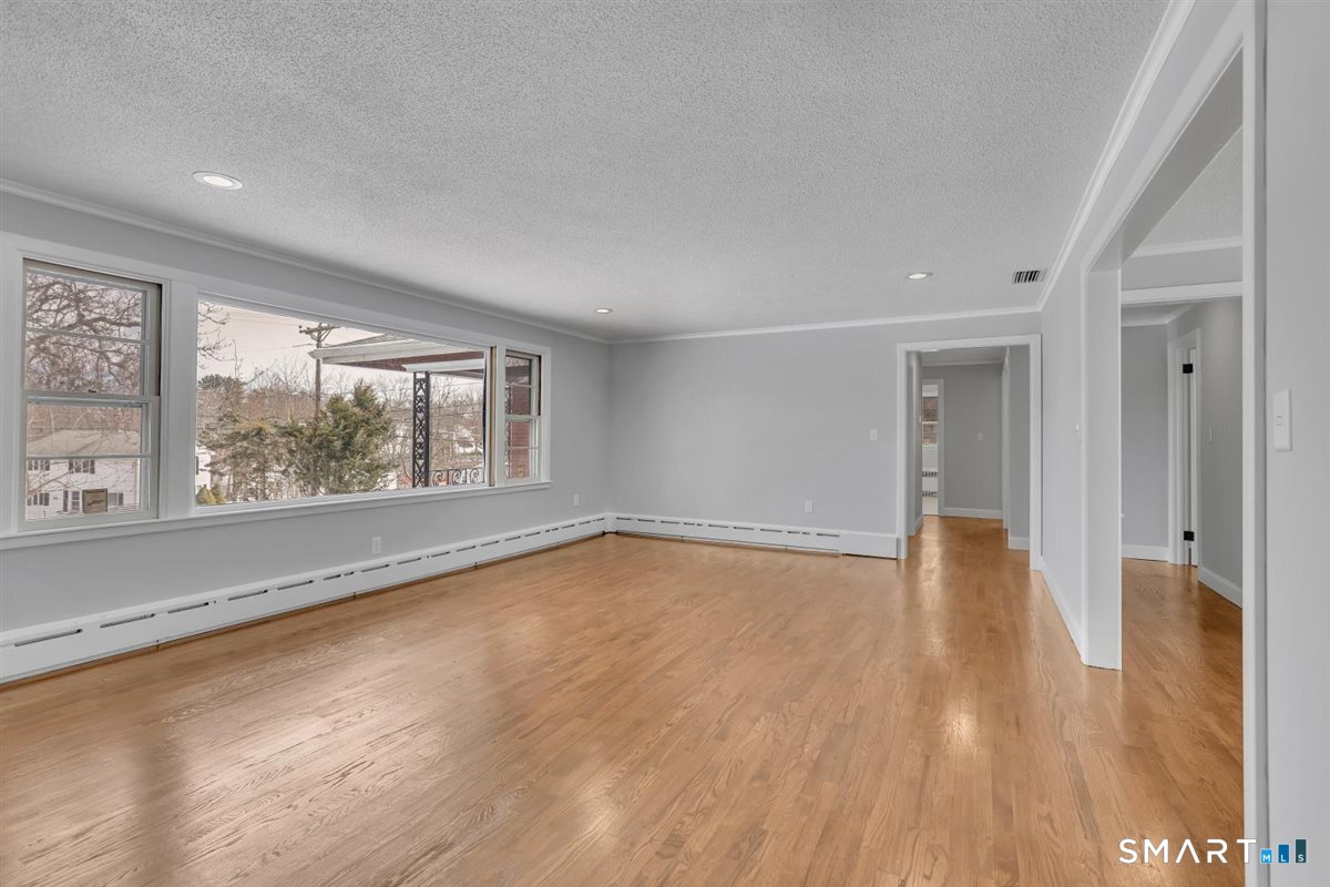 909 Randolph Road Middletown, CT 06457 - Photo 10 of 24 wooden floor in an empty room with a window