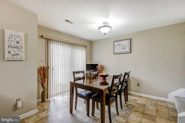 a view of a dining room with furniture and a chandelier