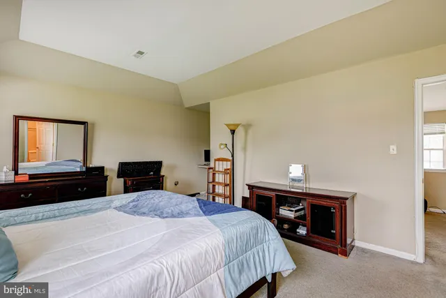 a bedroom with a bed and a dresser