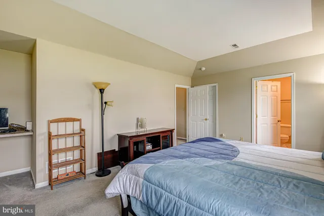 a bathroom with a double vanity sink mirror and toilet