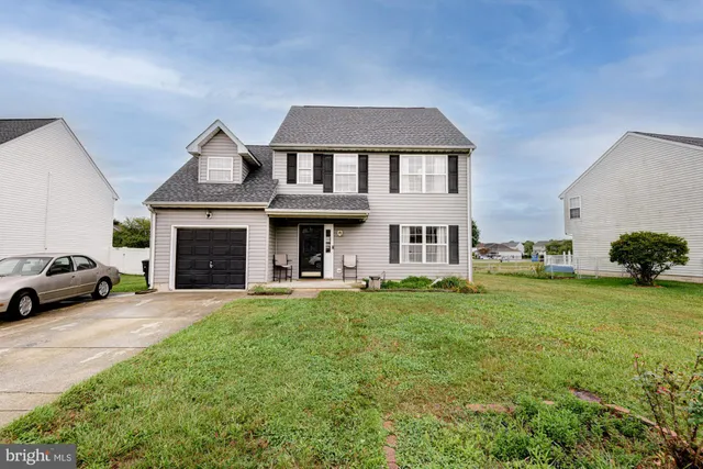 a front view of a house with a garden and yard