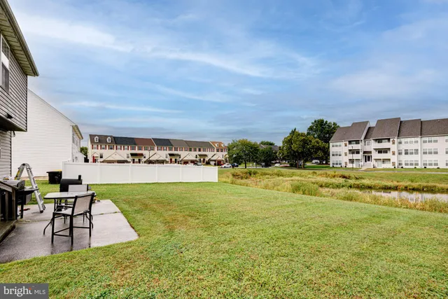 a swimming pool with outdoor seating and yard