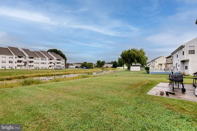 a view of swimming pool with outdoor seating and garden