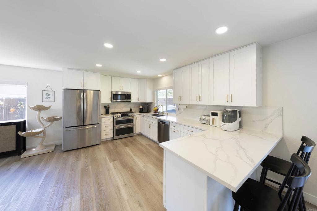 3577 Winslow Road Oceanside, CA 92056 - Photo 11 of 53 a kitchen with refrigerator cabinets and wooden floor