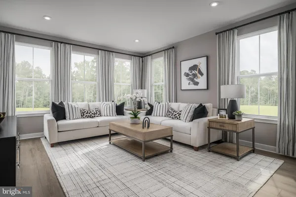 a living room with furniture and large windows