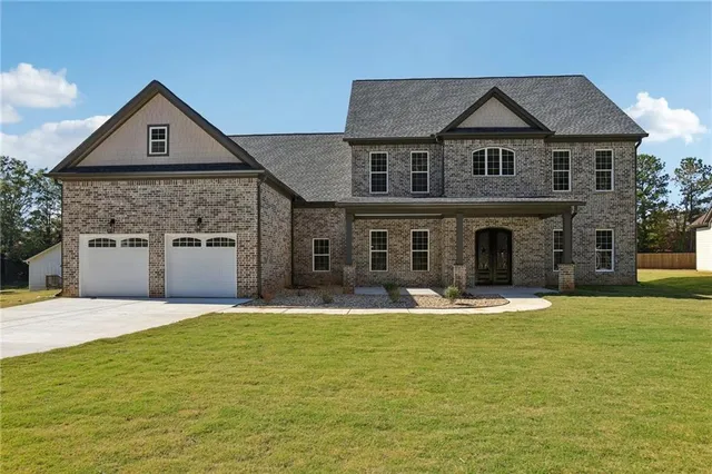 a front view of a house with a yard