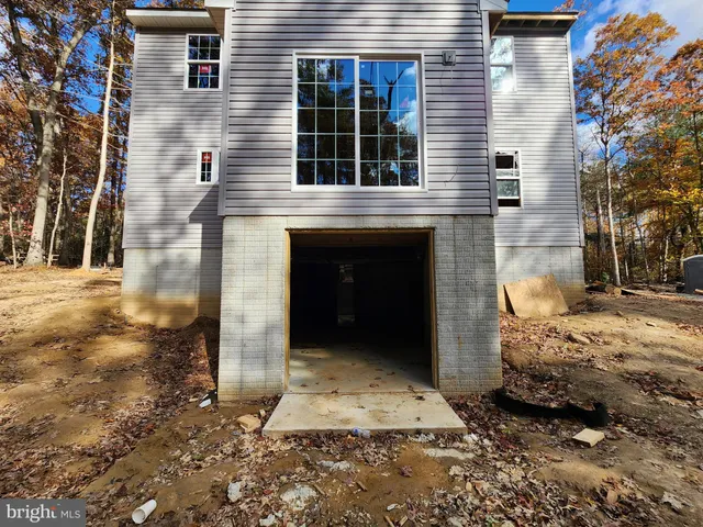 a view of a white house with a yard
