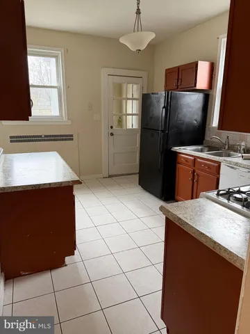 a kitchen with stainless steel appliances a refrigerator sink and microwave