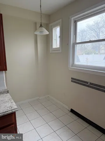 a kitchen with granite countertop a refrigerator and a stove top oven