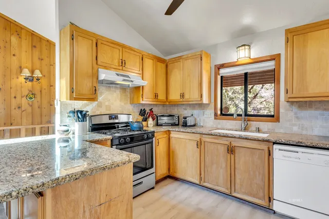a kitchen with a sink appliances and cabinets