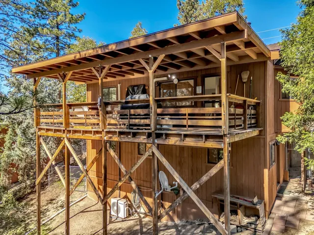 an aerial view of a house with a yard and balcony