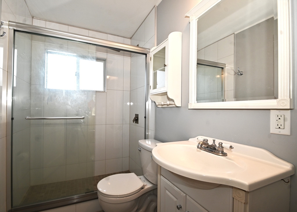 48 Porter Road Natick, MA 01760 - Photo 15 of 18 a bathroom with a sink a toilet and shower