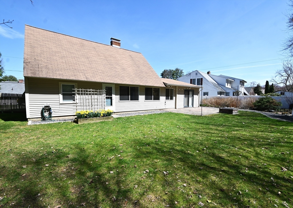 48 Porter Road Natick, MA 01760 - Photo 17 of 18 a front view of a house with a garden and trees