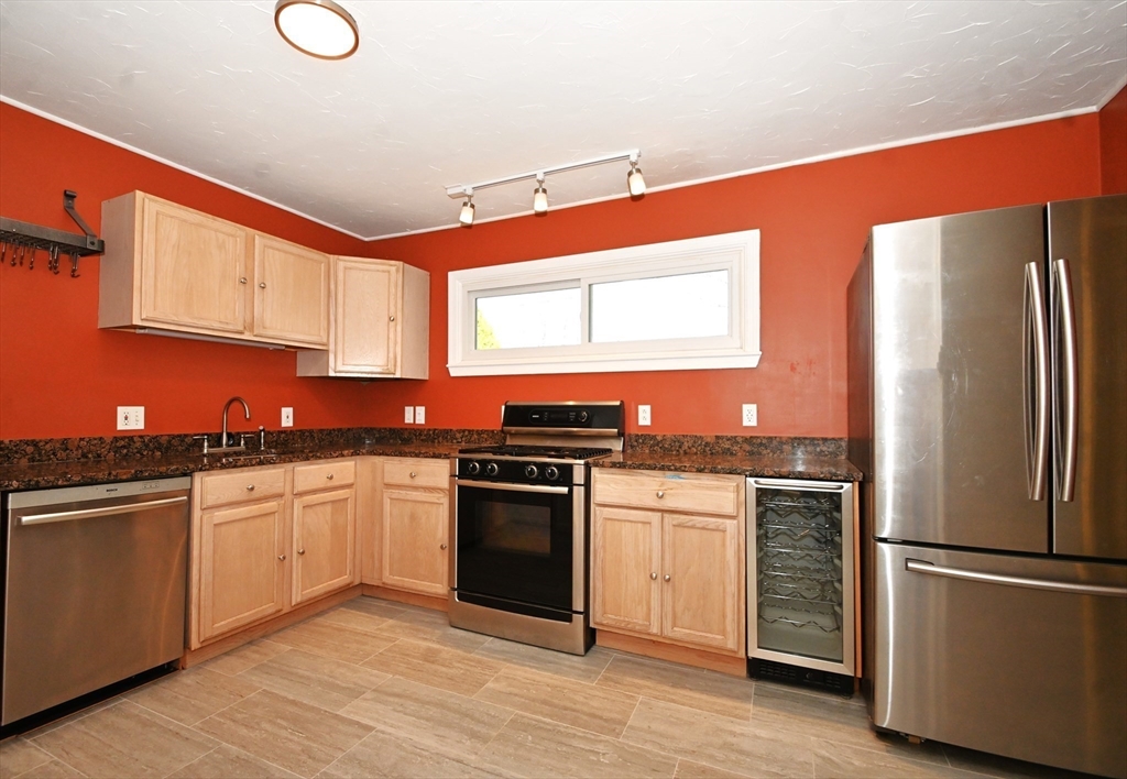 48 Porter Road Natick, MA 01760 - Photo 4 of 18 a kitchen with stainless steel appliances granite countertop a refrigerator sink and stove
