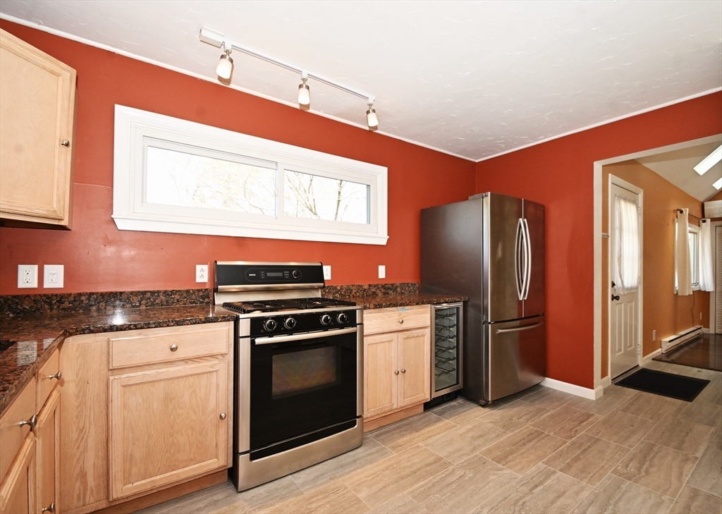 48 Porter Road Natick, MA 01760 - Photo 5 of 18 a kitchen with stainless steel appliances granite countertop a stove a refrigerator and a microwave