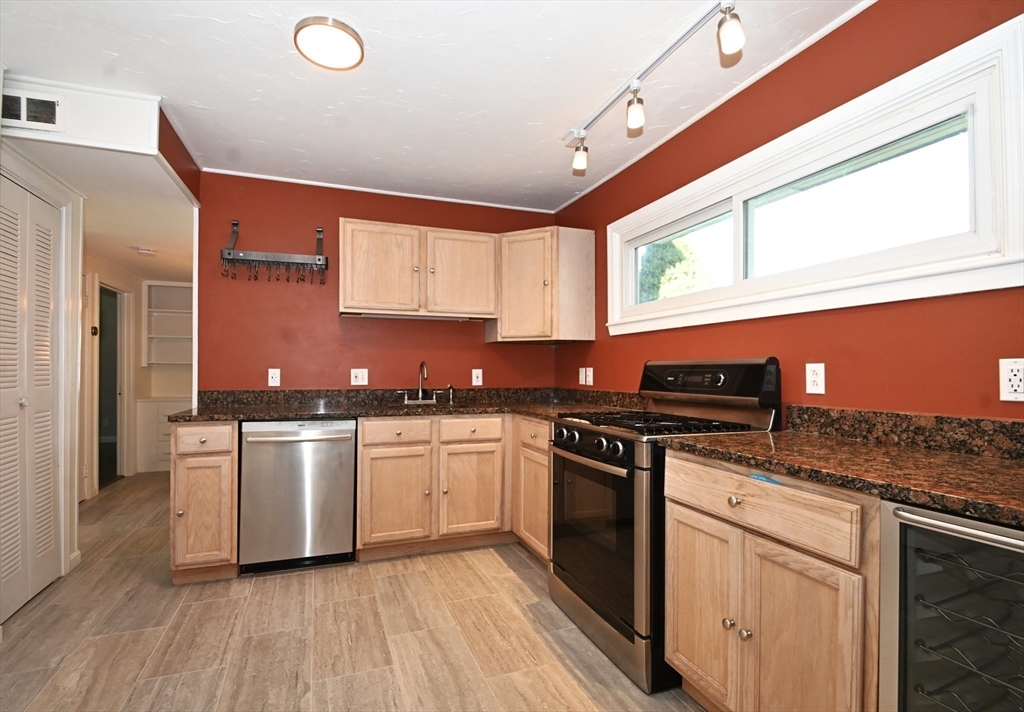 48 Porter Road Natick, MA 01760 - Photo 6 of 18 a kitchen with stainless steel appliances granite countertop a stove a sink and a microwave
