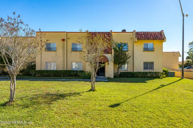 a view of swimming pool with lawn chairs next to yard