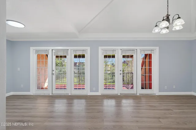 a view of wooden floor and windows in a room