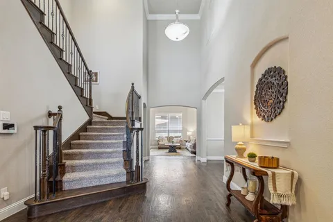 a view of entryway and hall with wooden floor