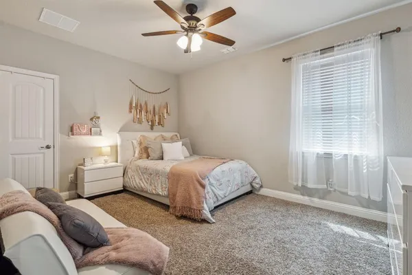 a bed room with a bed and a chandelier