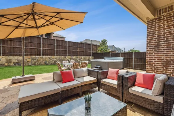 a view of backyard with swimming pool and outdoor seating