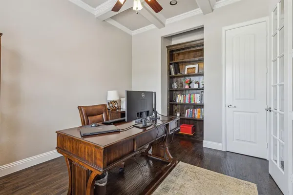 a work room with furniture wooden floor and book shelf