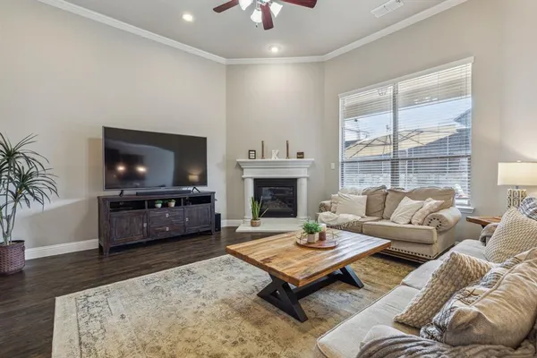 a living room with furniture a flat screen tv and a fireplace