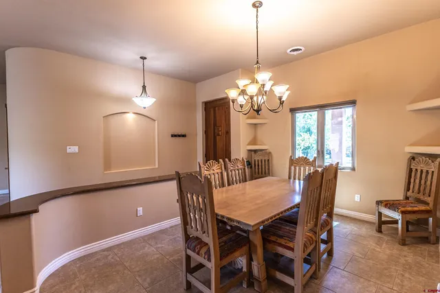 a view of a dining room with furniture and chandelier