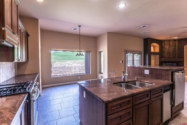 a kitchen with a sink stove and cabinets