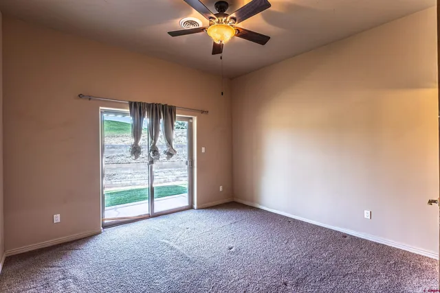 a view of a livingroom with a ceiling fan and window