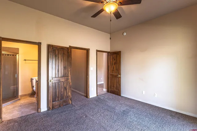an empty room with chandelier fan