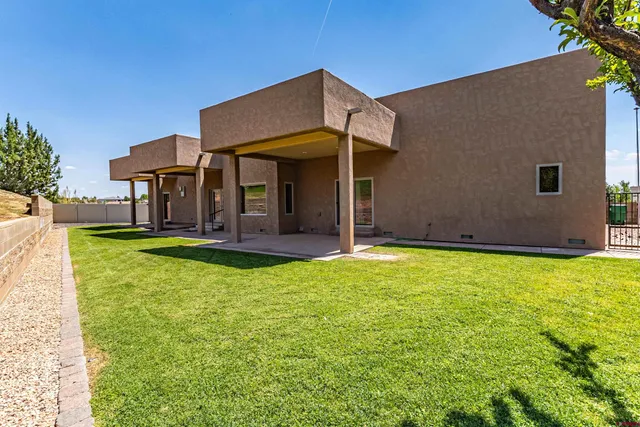 a backyard of a house with yard and outdoor seating