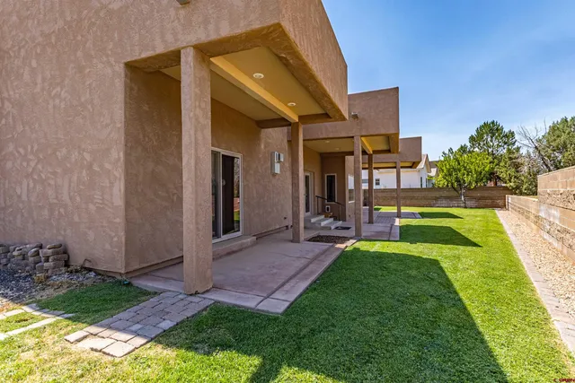 a view of a house with backyard porch and sitting area