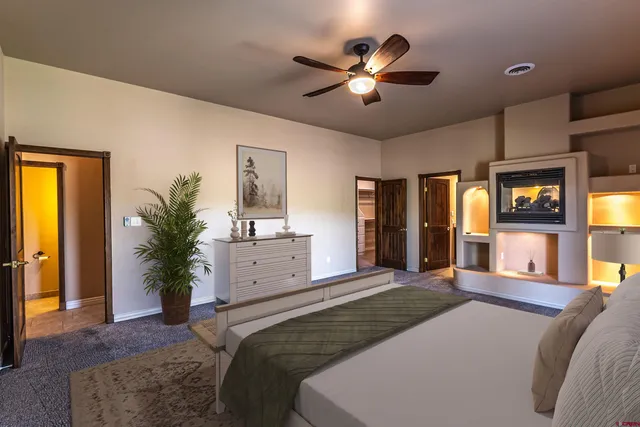 a bedroom with a large bed and a chandelier