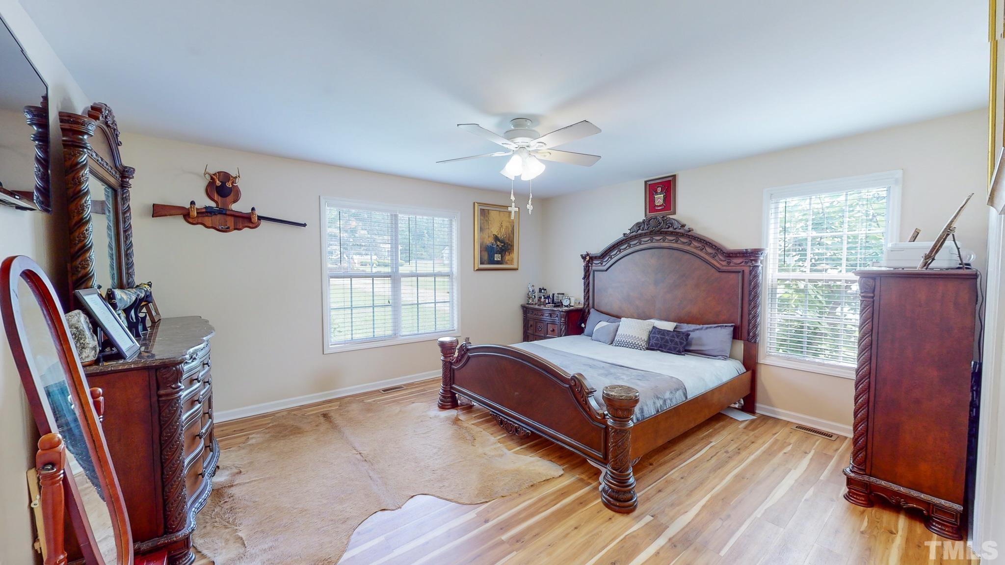 159 Punch Hill Farm Road Rougemont, NC 27572 - Photo 11 of 43 a bedroom with a bed and wooden floor