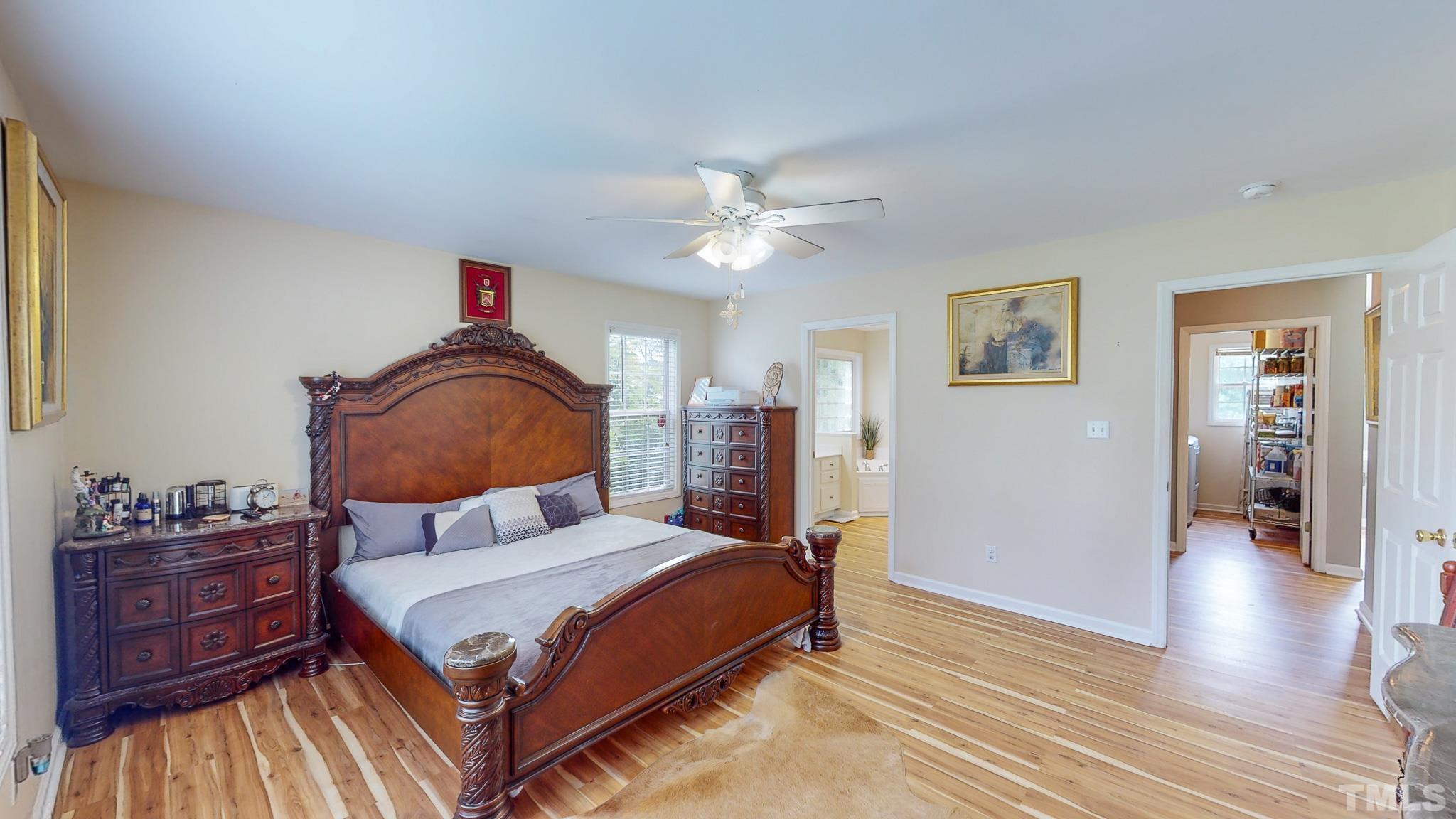 159 Punch Hill Farm Road Rougemont, NC 27572 - Photo 12 of 43 a bedroom with a bed and wooden floor