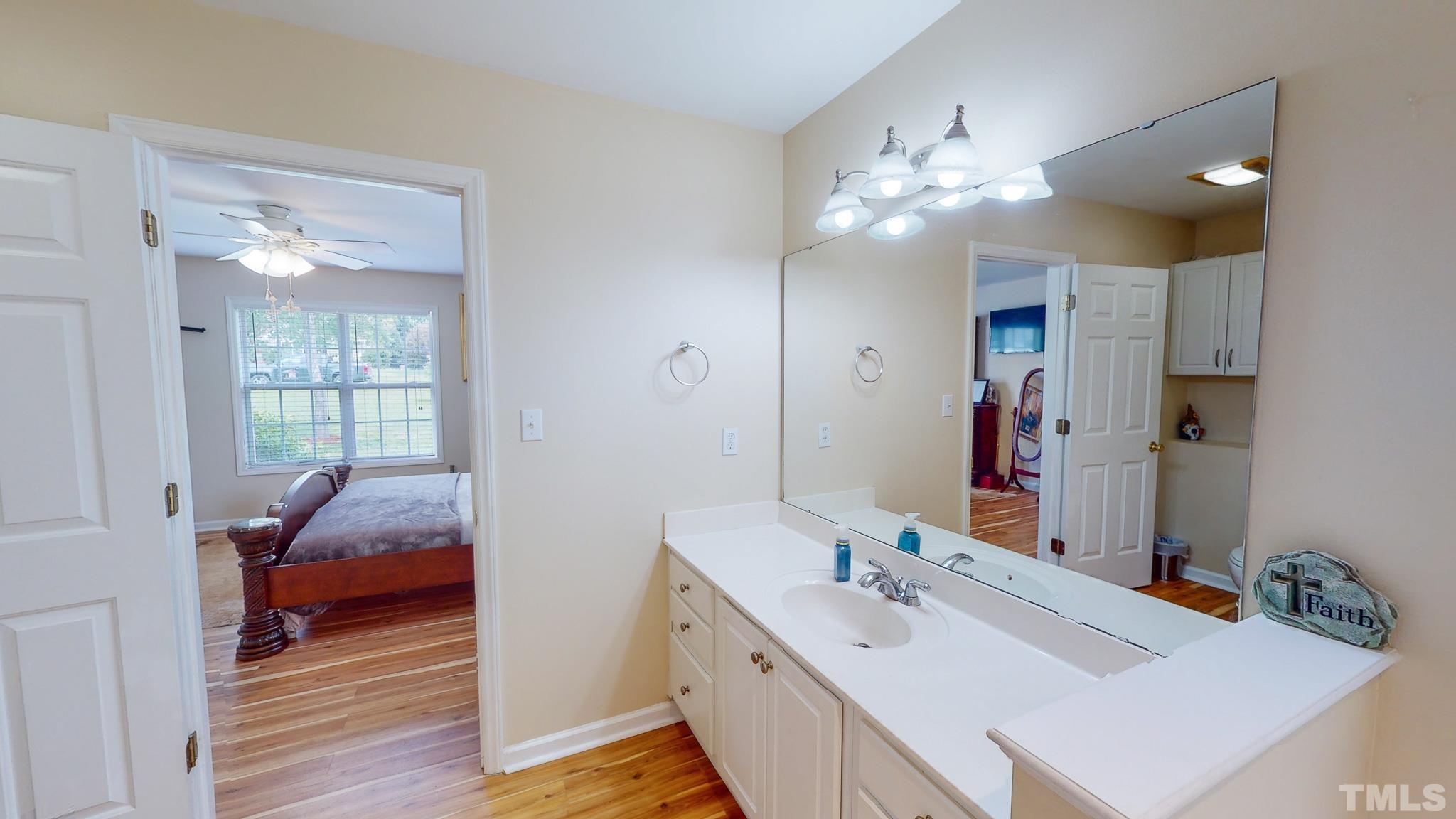 159 Punch Hill Farm Road Rougemont, NC 27572 - Photo 14 of 43 a en suite bathroom with a double vanity sink and a mirror